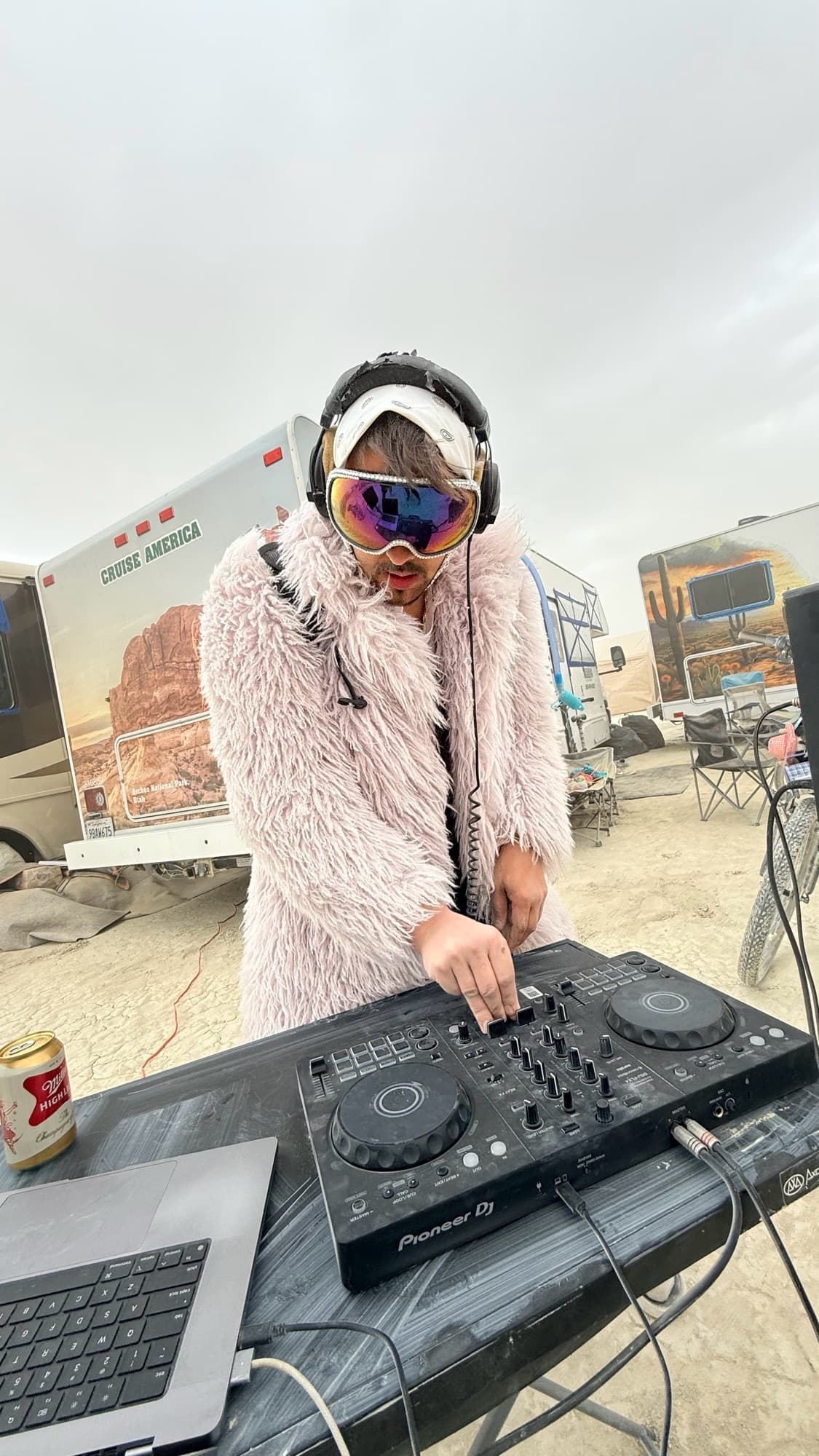 ARSKGG DJing in a fur coat and goggles at Burning Man